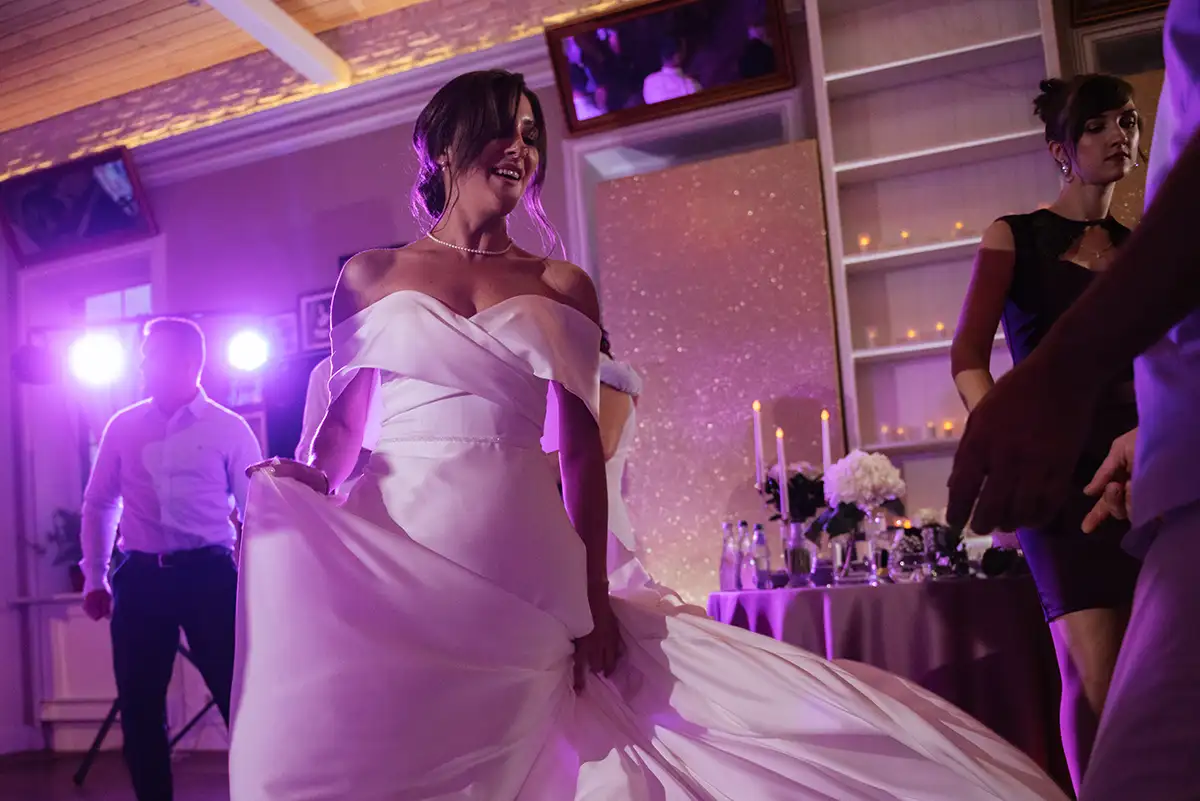 Guests dancing energetically at a wedding reception